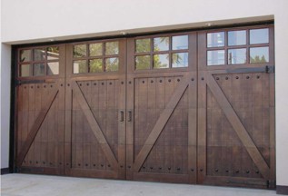Dark stained custom wood carriage house garage door with X braces