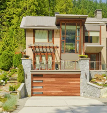 Modern plank steel garage door with woodgrain finish on a contemporary home